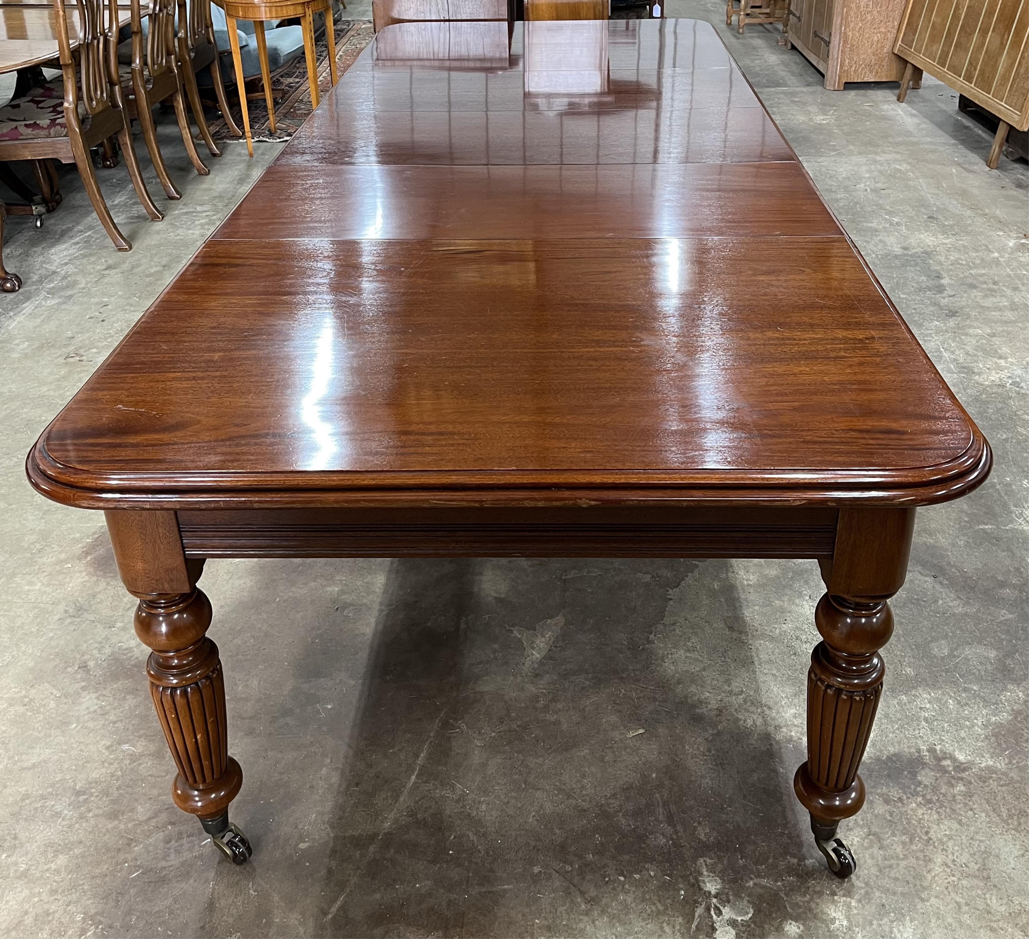 A reproduction Victorian style mahogany extending dining table, 310cm extended, three spare leaves, depth 123cm, height 79cm. Condition - fair to good